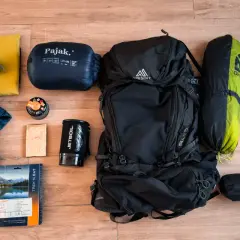 Sac à dos, sac de couchage, tente, réchaud, gourde, vêtements et nourriture : tout le nécessaire pour le camping.