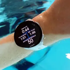 Montre Garmin Forerunner 55 en action pour la natation, affichant le temps d'intervalle et la distance.