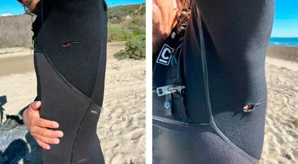 Un homme montre sa combinaison néoprène déchirée, un problème à résoudre pour réparer combinaison néoprène avant la prochaine session.